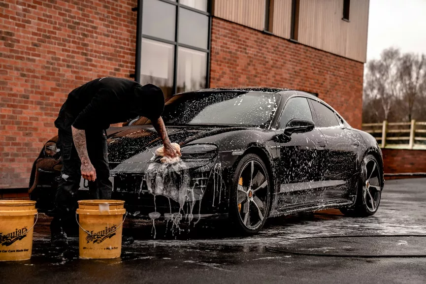 A man is washing the car